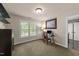 Well-lit office space featuring a desk setup, large window, and a neutral color scheme at 205 Benwell Ct, Cary, NC 27519