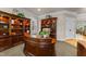 Elegant office with custom built-in bookshelves, plush carpet, and a classic executive desk at 205 Benwell Ct, Cary, NC 27519