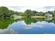 Picturesque pond reflecting the sky, with waterfront homes nestled among green trees along the opposite shore at 205 Benwell Ct, Cary, NC 27519