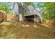 Backyard of home featuring deck, brick foundation, and mature trees at 214 Wax Myrtle Ct, Cary, NC 27513