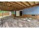 Exterior basement entrance with brick foundation and wooden ceiling, and backyard with a privacy fence at 214 Wax Myrtle Ct, Cary, NC 27513