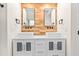 Bathroom featuring double vanities and wood accent wall at 214 Wax Myrtle Ct, Cary, NC 27513