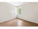Clean and bright bedroom with luxury vinyl floors, a window, and a door at 214 Wax Myrtle Ct, Cary, NC 27513