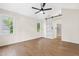 Spacious bedroom featuring luxury vinyl floors, modern ceiling fan, and barn door to ensuite bathroom at 214 Wax Myrtle Ct, Cary, NC 27513