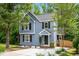 Charming two-story home with blue siding, black shutters, and a well-manicured lawn, creating a welcoming curb appeal at 214 Wax Myrtle Ct, Cary, NC 27513