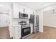 Modern kitchen featuring white cabinets, stainless steel appliances, and sleek countertops, designed for culinary enthusiasts at 214 Wax Myrtle Ct, Cary, NC 27513