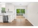 Bright kitchen with white cabinets, stainless steel appliances, and sliding doors to a deck at 214 Wax Myrtle Ct, Cary, NC 27513