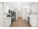 Modern kitchen featuring white cabinets, stainless steel appliances, and sleek countertops, designed for culinary enthusiasts at 214 Wax Myrtle Ct, Cary, NC 27513