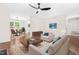 Cozy living room with hardwood floors, neutral sofas, and a view into the dining and kitchen areas, perfect for Gathering time at 214 Wax Myrtle Ct, Cary, NC 27513