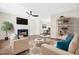 Bright living room with a fireplace, neutral furniture, and a view into the dining area, perfect for relaxing and entertaining at 214 Wax Myrtle Ct, Cary, NC 27513