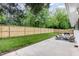 Spacious backyard with a new wood fence, lush green lawn, and a concrete patio furnished with outdoor seating at 2205 W Carver St, Durham, NC 27705