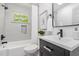 Stylish bathroom featuring an updated vanity, tub, and modern fixtures, perfect for relaxation at 2205 W Carver St, Durham, NC 27705