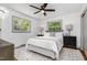 Bright bedroom featuring a ceiling fan, two large windows, and neutral decor at 2205 W Carver St, Durham, NC 27705