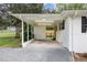 Attached carport with concrete flooring and overhead lighting at 2205 W Carver St, Durham, NC 27705
