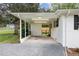 Attached carport featuring ample space, overhead lighting, and easy access to the fenced backyard at 2205 W Carver St, Durham, NC 27705