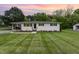 Charming white brick home with a well-manicured lawn and freshly planted landscaping at 2205 W Carver St, Durham, NC 27705