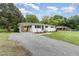 Side view of charming home with carport and gravel driveway on a sunny day at 2205 W Carver St, Durham, NC 27705