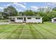Charming single-story home with a well-manicured lawn, a convenient carport, and freshly landscaped flowerbeds at 2205 W Carver St, Durham, NC 27705