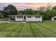 Charming single-story home with freshly cut lawn, brick stairs, and manicured landscaping at 2205 W Carver St, Durham, NC 27705