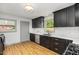 Updated kitchen with black cabinets, white countertops, and stainless steel appliances at 2205 W Carver St, Durham, NC 27705