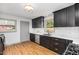 Modern kitchen featuring dark cabinets, white countertops, and stainless steel appliances at 2205 W Carver St, Durham, NC 27705