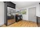 Laundry area with stainless steel appliances, countertop, and access door at 2205 W Carver St, Durham, NC 27705