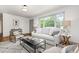 Inviting living room with a plush sofa, stylish coffee table, and large windows at 2205 W Carver St, Durham, NC 27705