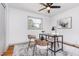 Bright home office features a ceiling fan, neutral color palette, and a patterned area rug at 2205 W Carver St, Durham, NC 27705