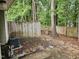 Backyard with wooden fence, trees, and concrete patio at 225 Virens Drive, Cary, NC 27511