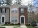 Charming two-story townhouse with brick and siding exterior, well-maintained landscaping, and welcoming entryway at 225 Virens Drive, Cary, NC 27511