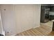 Hallway with closet and wood-look flooring that connects to the kitchen with stainless steel appliances at 225 Virens Drive, Cary, NC 27511