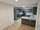 Well-lit kitchen featuring gray cabinets, stainless steel appliances, and granite countertops at 225 Virens Drive, Cary, NC 27511