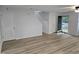 Open-concept living room with wood-look floors, staircase, and an entry door at 225 Virens Drive, Cary, NC 27511