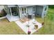 Aerial view of a patio with a fire pit, outdoor seating, string lights, and landscaped yard at 2409 New Hope Church Rd, Chapel Hill, NC 27514