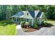 Well-maintained home with a gray roof, gray siding, and mature landscaping on a large lot at 2409 New Hope Church Rd, Chapel Hill, NC 27514