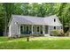 Inviting home with a covered porch, nicely landscaped yard, and a classic craftsman style at 2409 New Hope Church Rd, Chapel Hill, NC 27514