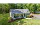Charming home featuring a welcoming front porch, beautifully landscaped front yard, and a serene wooded backdrop at 2409 New Hope Church Rd, Chapel Hill, NC 27514