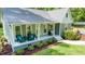 Charming home features a welcoming front porch and beautifully landscaped front yard with wooded backdrop at 2409 New Hope Church Rd, Chapel Hill, NC 27514