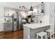 Inviting kitchen with stainless steel appliances, tile backsplash, and stylish breakfast bar seating at 2409 New Hope Church Rd, Chapel Hill, NC 27514
