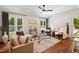 Bright living room with hardwood floors, neutral color palette, vaulted ceilings and large windows at 2409 New Hope Church Rd, Chapel Hill, NC 27514