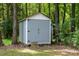 Small storage shed surrounded by mature trees on a wooded lot at 2409 New Hope Church Rd, Chapel Hill, NC 27514