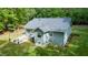 Rear view of the home, showing well-manicured lawn and an outdoor seating area at 2409 New Hope Church Rd, Chapel Hill, NC 27514