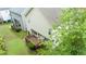 Exterior back view of home with inviting wooden deck, lush lawn and mature trees for privacy at 2420 Sapphire Valley Dr, Raleigh, NC 27604