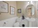 Charming powder room with white wainscoting, a pedestal sink, and decorative wall art at 2420 Sapphire Valley Dr, Raleigh, NC 27604