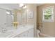 Bright bathroom with double sinks, large mirror, and walk-in shower with glass doors at 2420 Sapphire Valley Dr, Raleigh, NC 27604