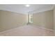Empty bedroom featuring neutral walls, beige carpet, and a window for natural light at 2420 Sapphire Valley Dr, Raleigh, NC 27604