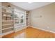 Bright bedroom featuring hardwood floors, built-in bookshelves, and a large window at 2420 Sapphire Valley Dr, Raleigh, NC 27604