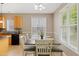 Dining room with a large table, seating for six, and a window with natural light at 2420 Sapphire Valley Dr, Raleigh, NC 27604
