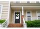 Close-up front entrance with brick steps, white porch and wreath at 2420 Sapphire Valley Dr, Raleigh, NC 27604