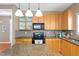 Kitchen showcasing wooden cabinets, granite countertops, and modern appliances at 2420 Sapphire Valley Dr, Raleigh, NC 27604